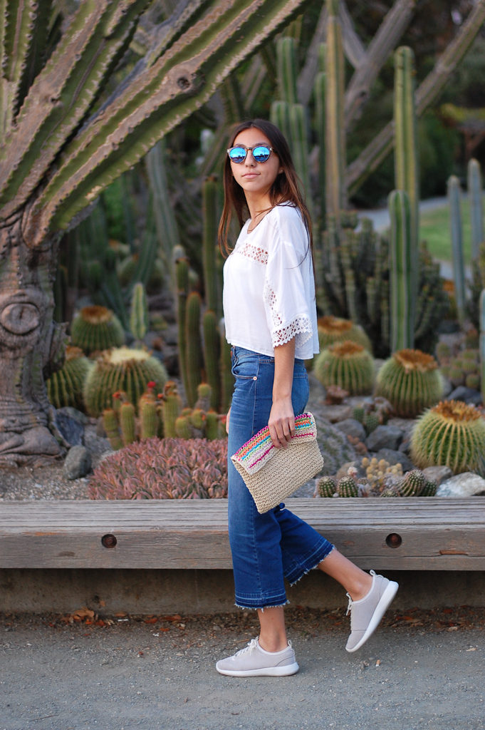 White crop top cropped jeans walking